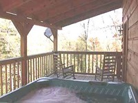 Log cabin with hot tub.