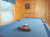 Log Cabin with a  pool table.